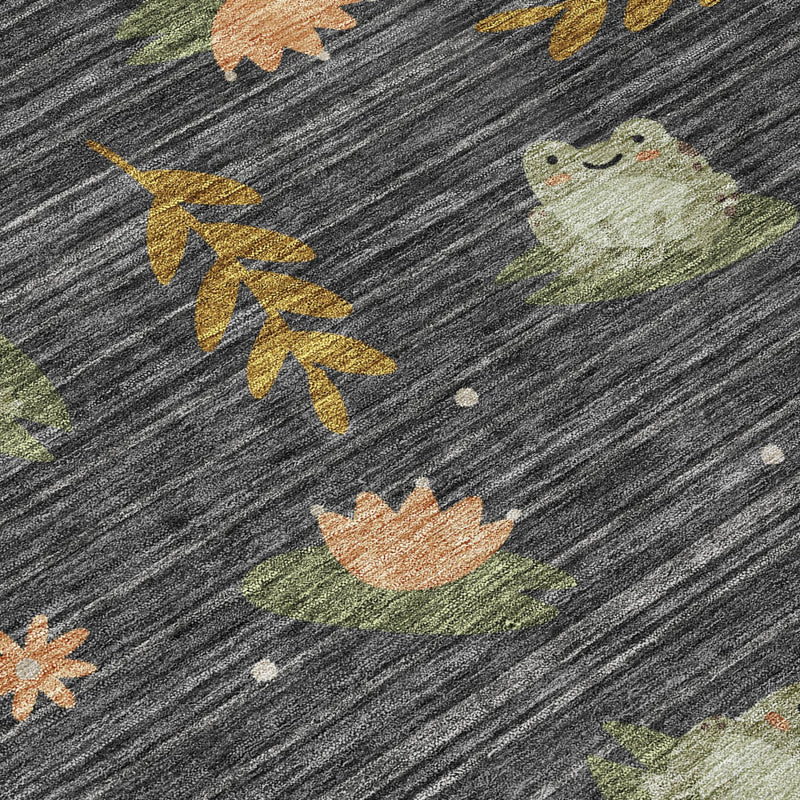 Botanical area rug close-up: dark charcoal with scattered leaf and bunny motifs.