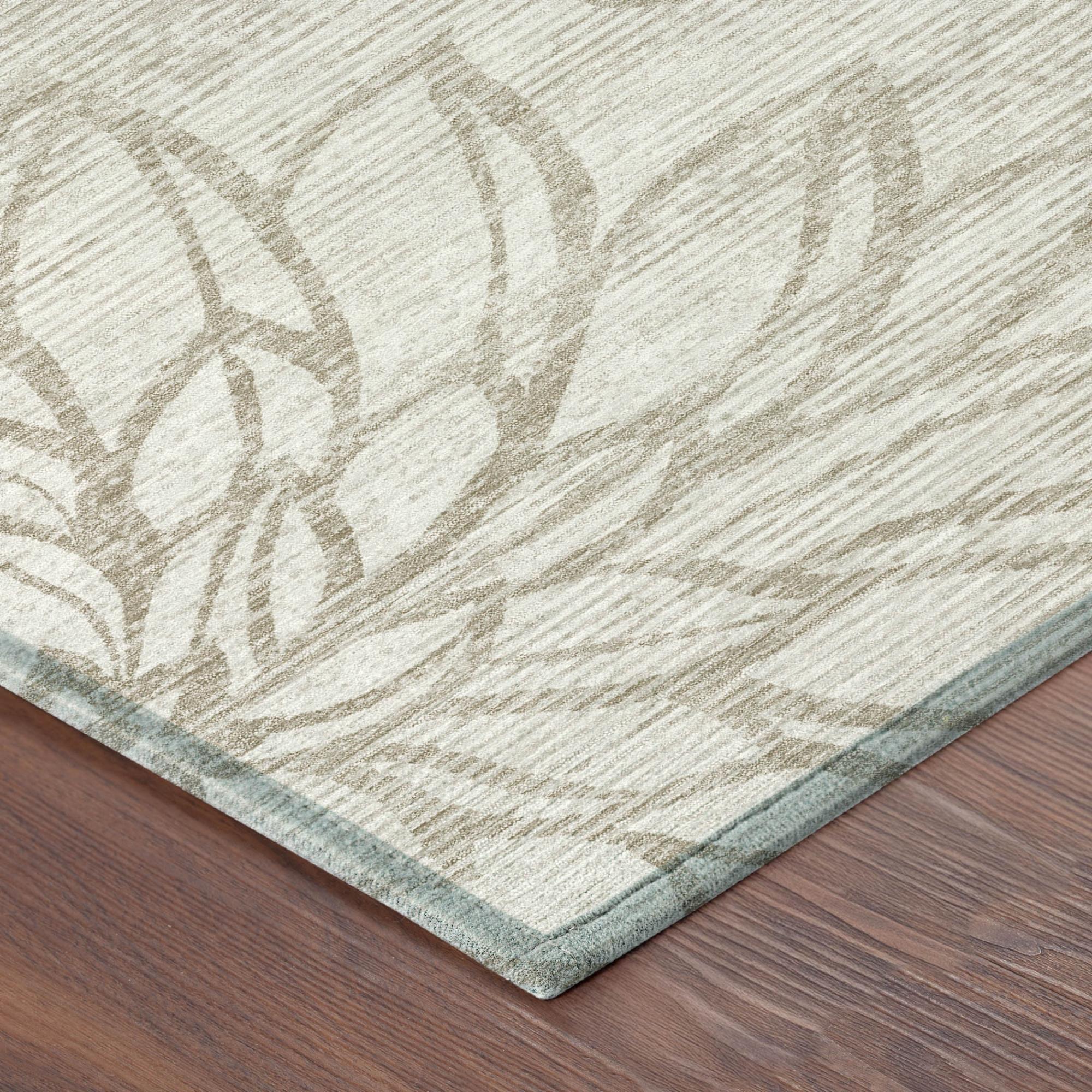 Ivory and silver floral area rug corner with visible low-pile edge
