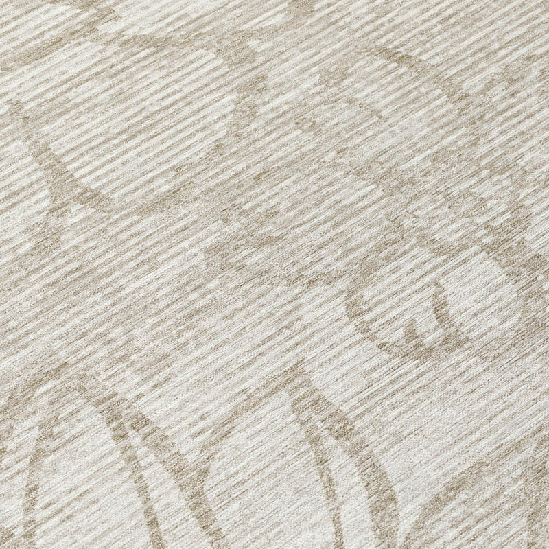 Close-up of ivory round area rug showing silver floral pattern texture