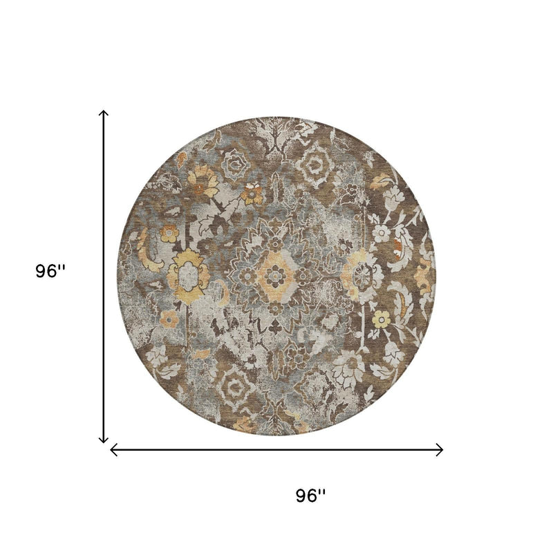 Round floral area rug with distressed beige, brown, blue-gray and mustard tones