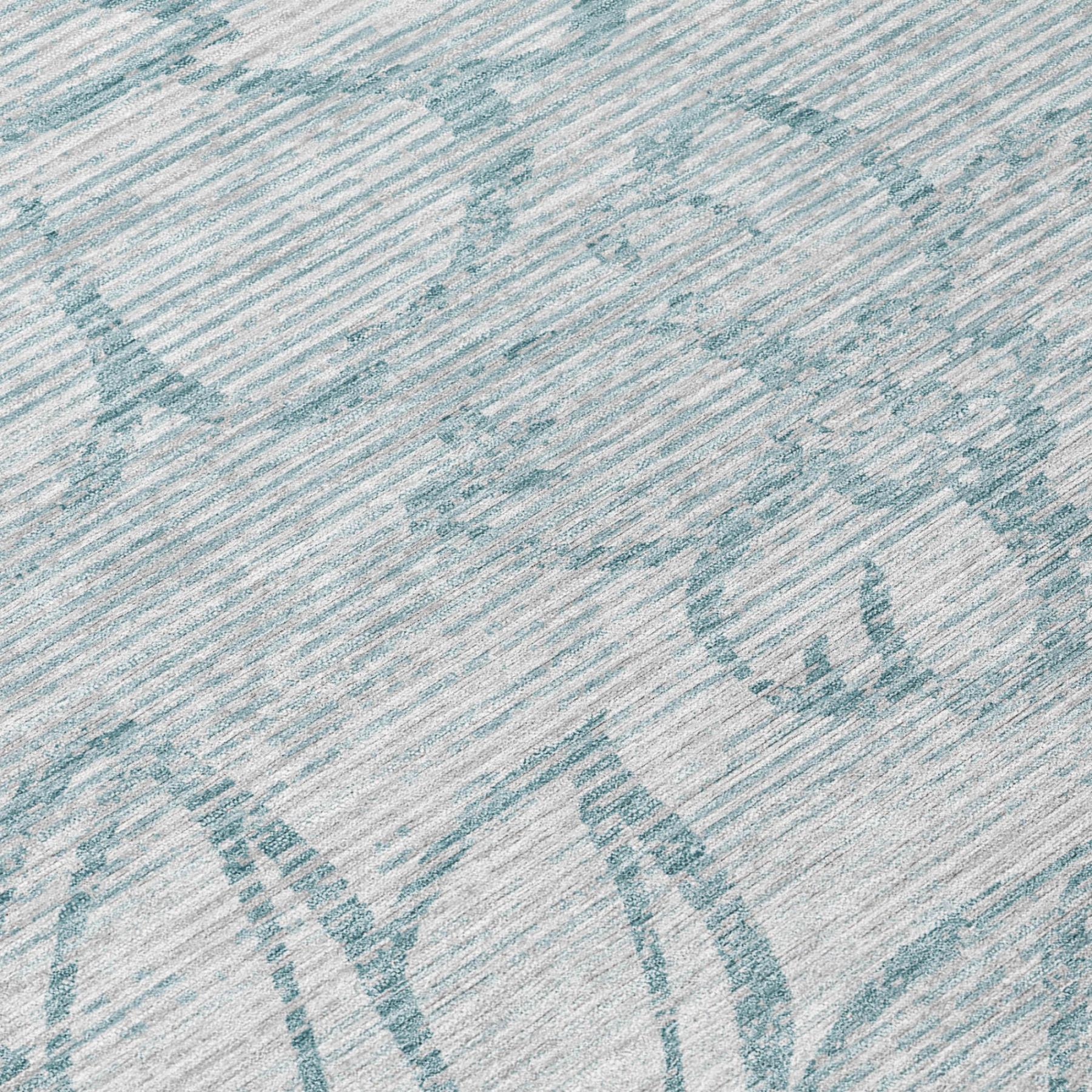 Close-up of light gray area rug texture with light blue floral motif