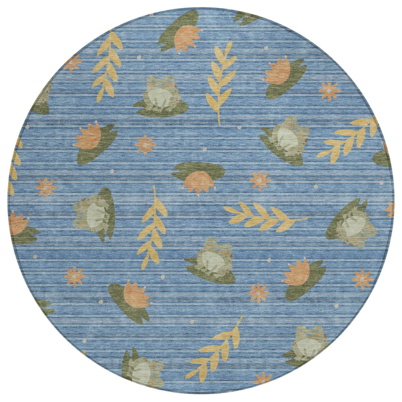 Round blue area rug featuring scattered botanical leaves in olive and orange
