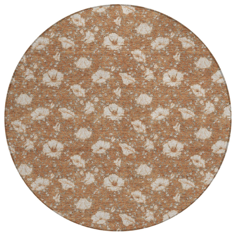 Rust and cream round area rug with repeating distressed floral medallion motifs