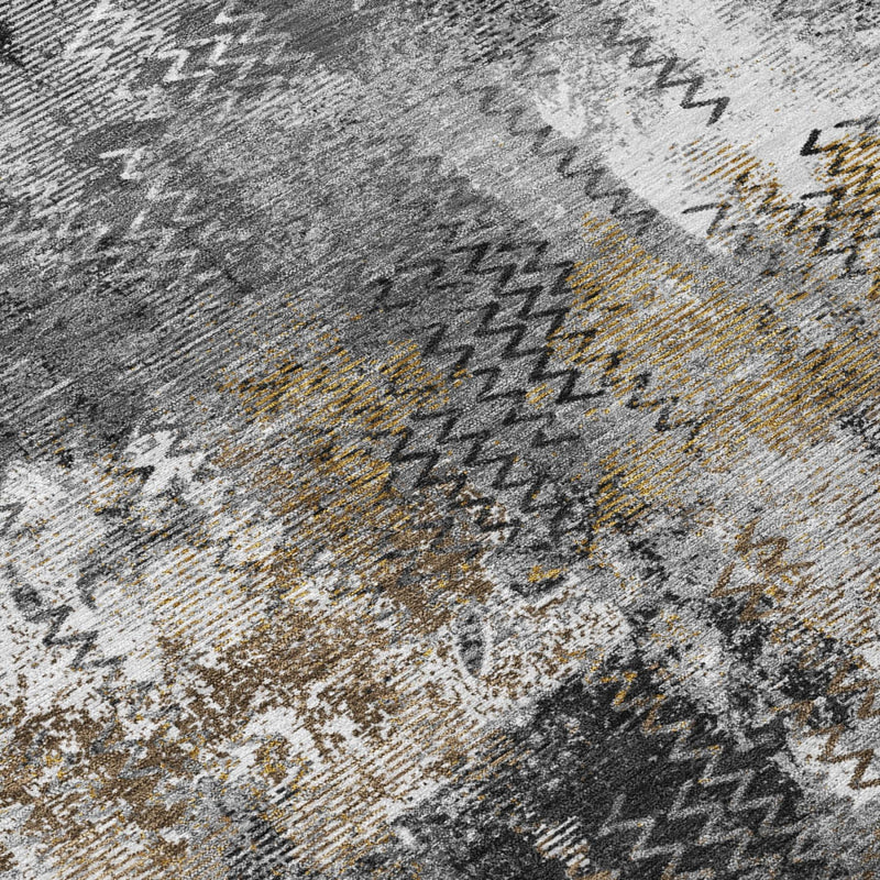 Close-up abstract area rug in gray with white and mustard accent stitches