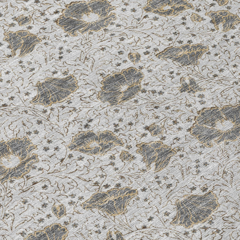 Silver and gray area rug with distressed floral medallion pattern, close-up top view