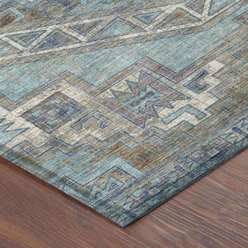 Teal blue and gray Southwestern area rug with textured geometric motifs, angled view