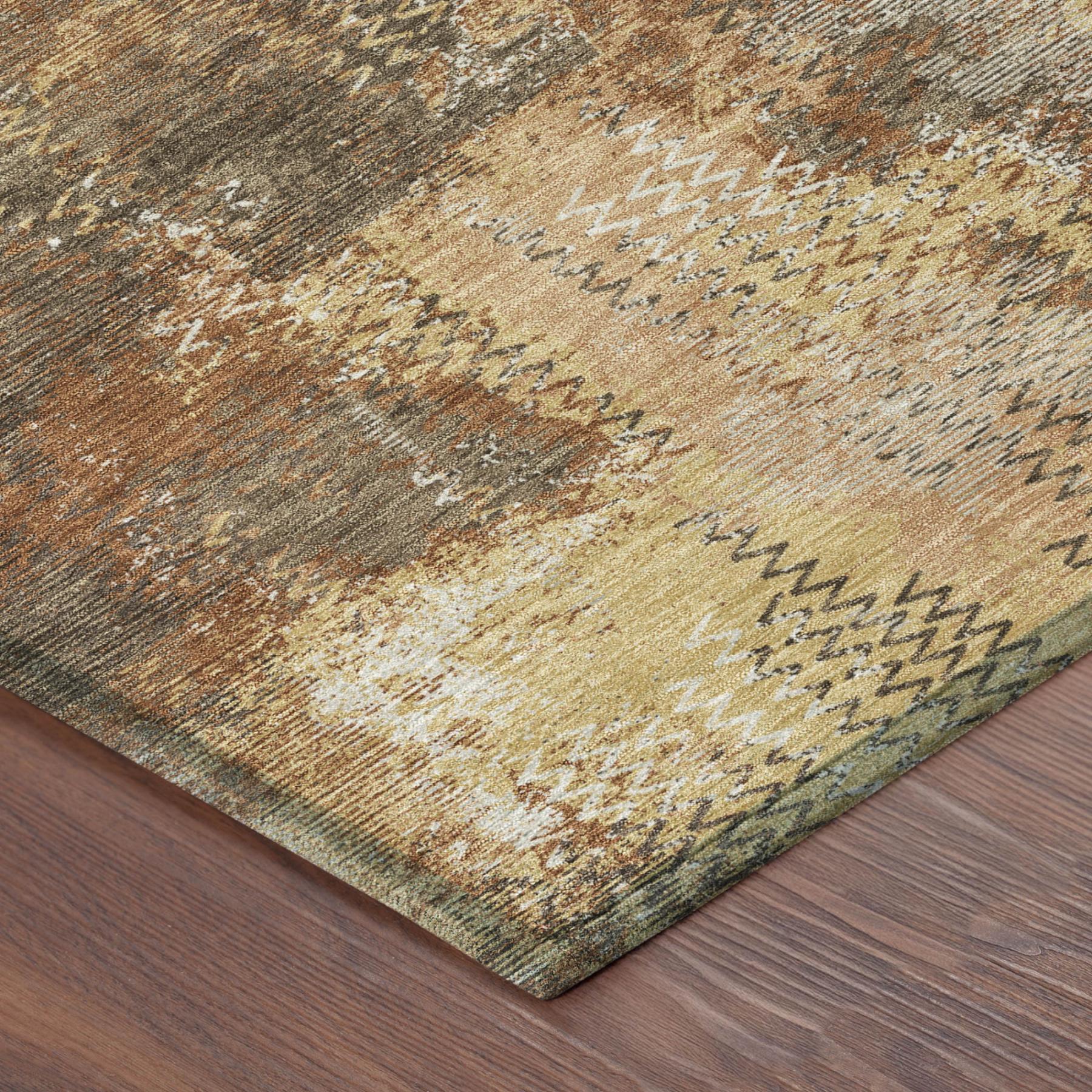 Corner of copper, orange and gray abstract area rug with zigzag border texture