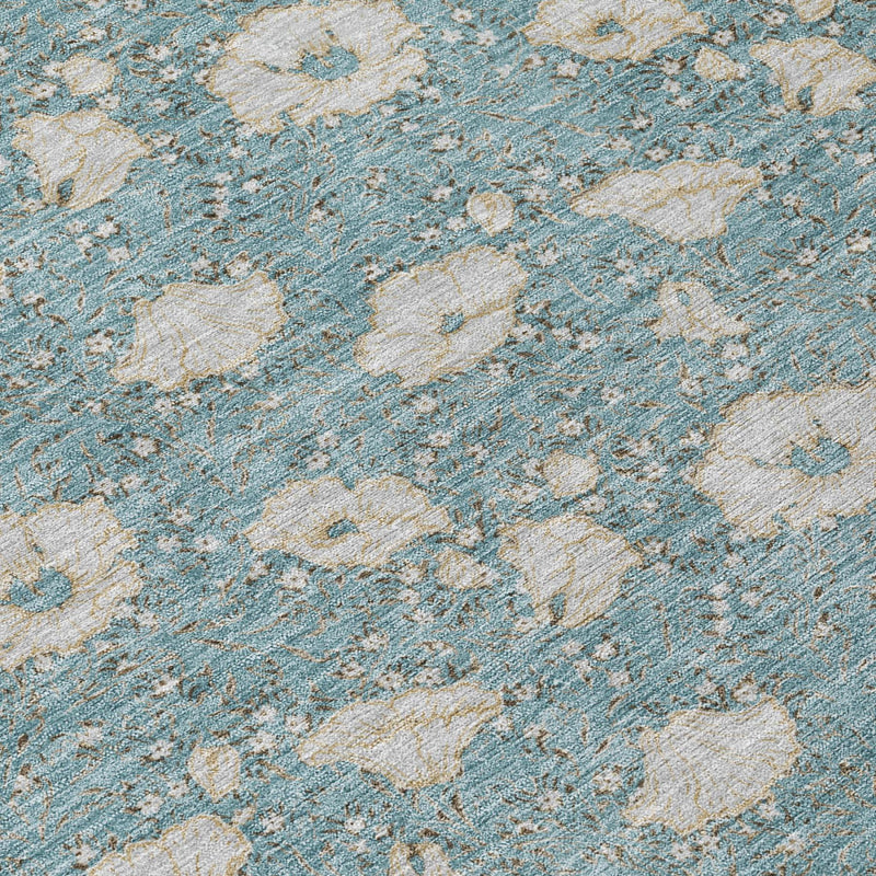 Teal blue rug with light pewter floral motifs and textured, distressed look