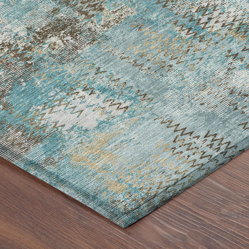 Teal blue abstract area rug with pewter and cream mottled sections, corner detail