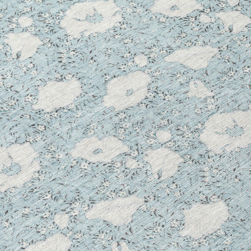 Close-up of sky and light-blue textured floral pattern on area rug
