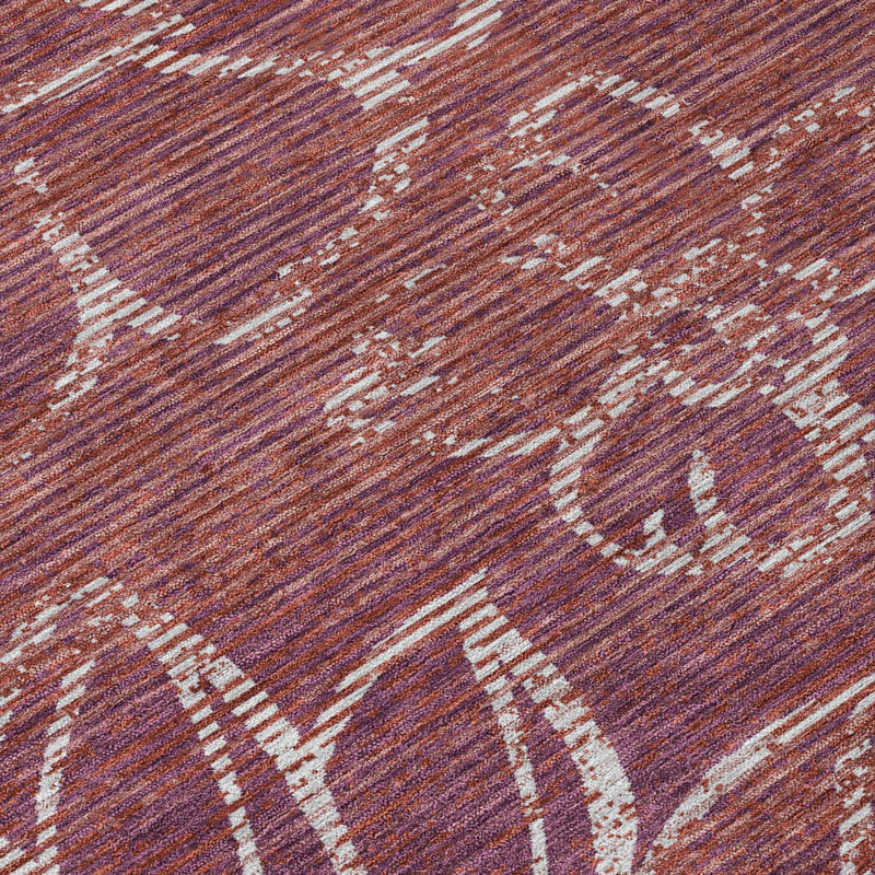 Close-up of eggplant area rug with distressed floral outlines and cream speckles