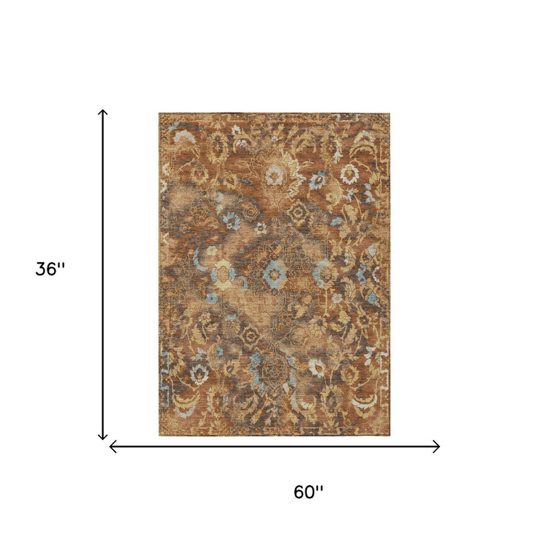 Floral area rug, 60 in x 36 in, rust and tan with blue details