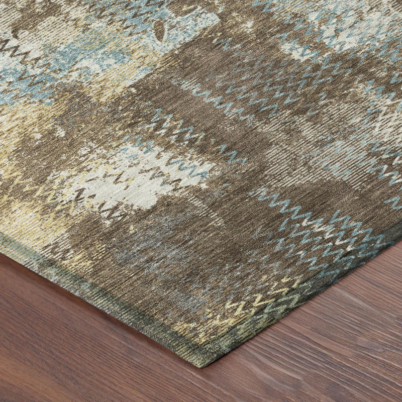 Round abstract area rug with brown, cream, and light blue distressed pattern