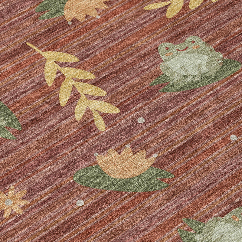 Close-up of red and merlot area rug with green leaves, birds, and speckled texture