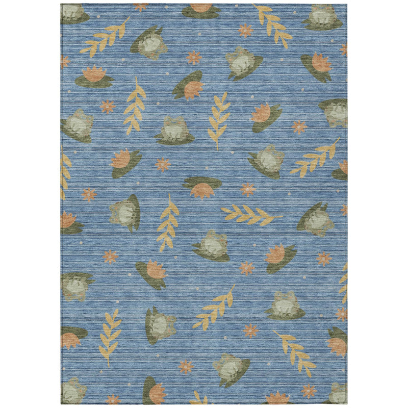 Blue indoor outdoor area rug with scattered botanical leaves in olive, green and orange