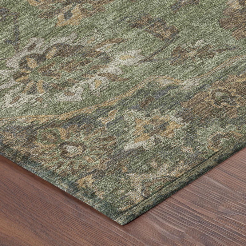 Olive green area rug corner with distressed green floral medallion weave and textured edge.