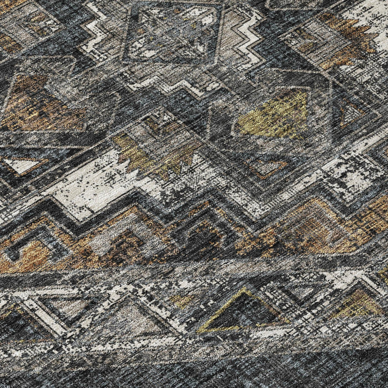 Geometric Southwestern area rug close-up in dark gray with tan and muted yellow accents