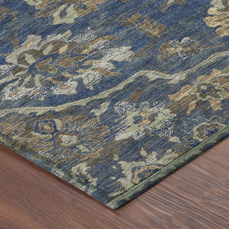 Corner of round blue area rug with cream and gold floral medallion pattern