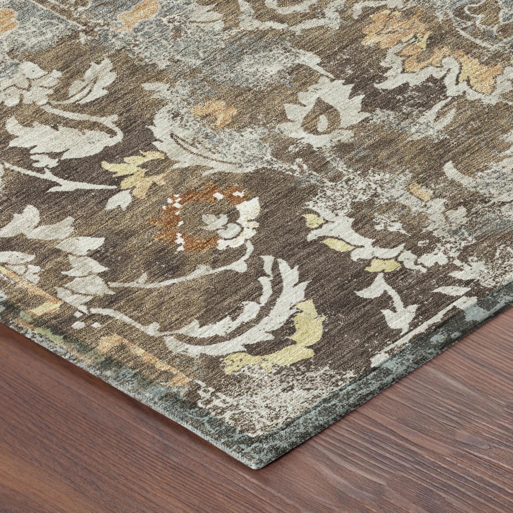 Corner close-up of distressed floral area rug in brown, coffee, and cream tones
