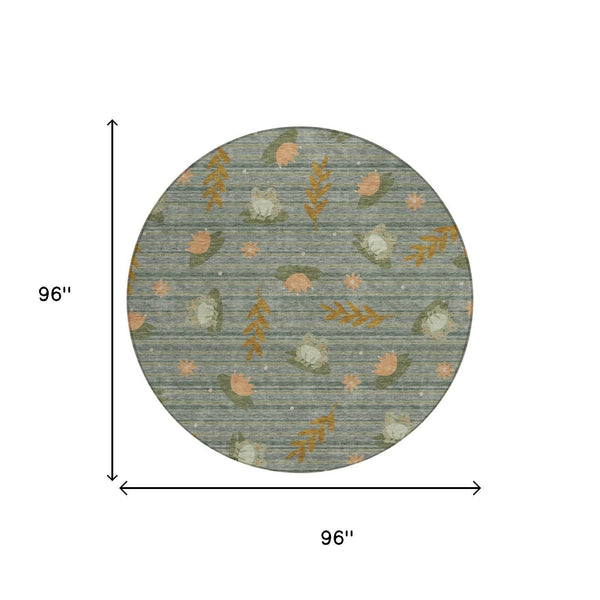 Round botanical area rug with blue-gray ground and orange leaf pattern
