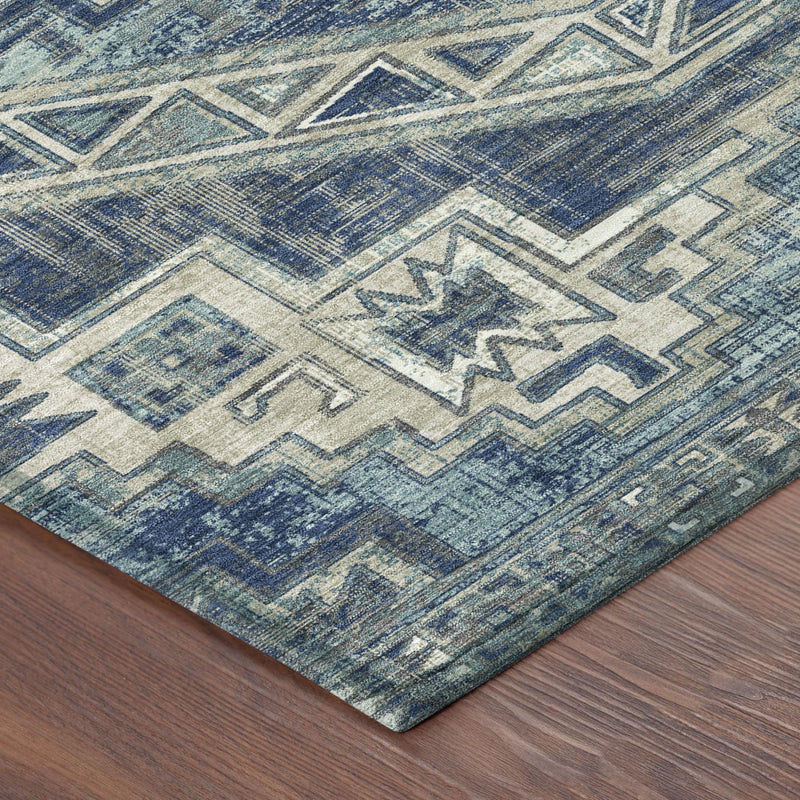Blue and cream Southwestern geometric area rug with worn texture and zigzag borders