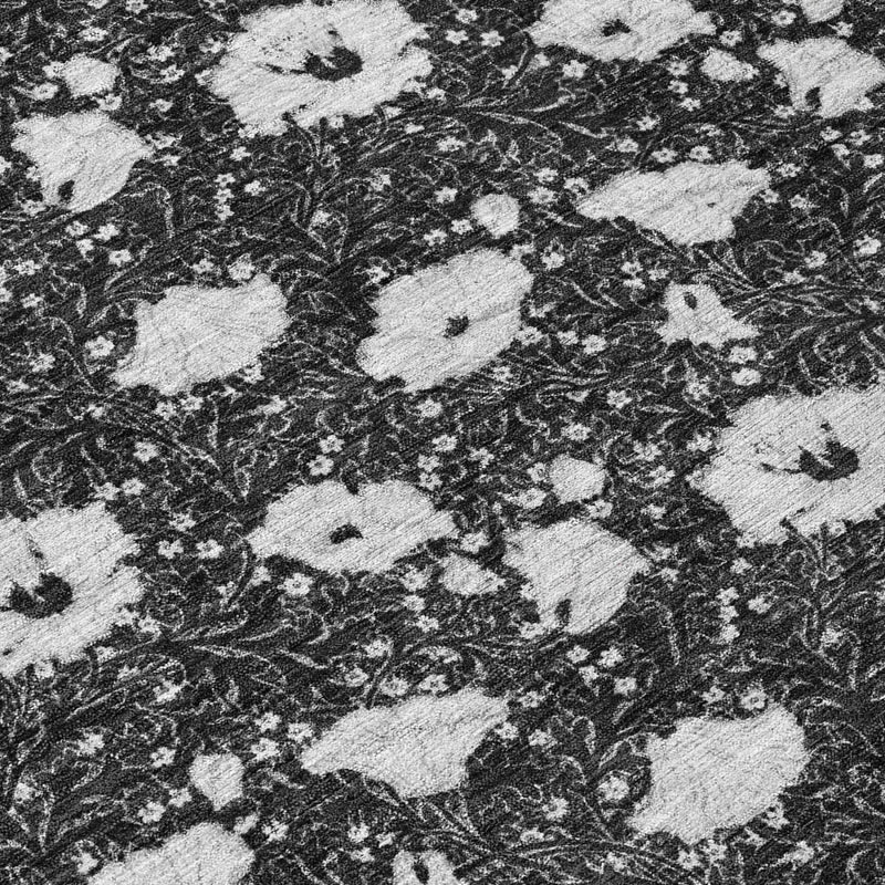 Floral area rug pattern close-up in black with light gray motifs and swirling details
