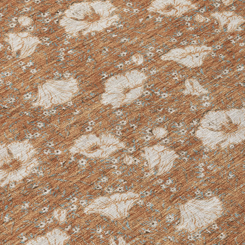 Rust and orange rug with cream floral medallion pattern, close-up textured weave