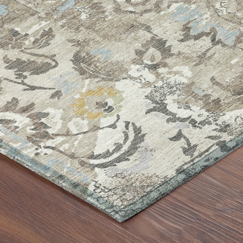 Corner close-up of round floral area rug, ivory and pewter with light blue and yellow flecks