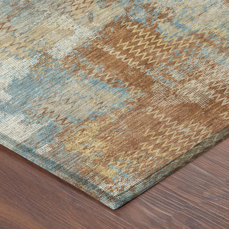 Round abstract area rug with rust orange, light blue, and beige zigzag texture.