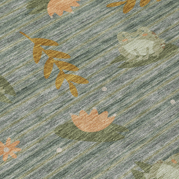 Green area rug with muted botanical leaf pattern in tan and orange