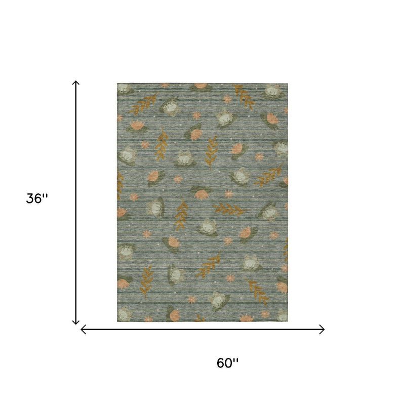 Rectangular green rug with botanical leaf pattern; 36 in by 60 in