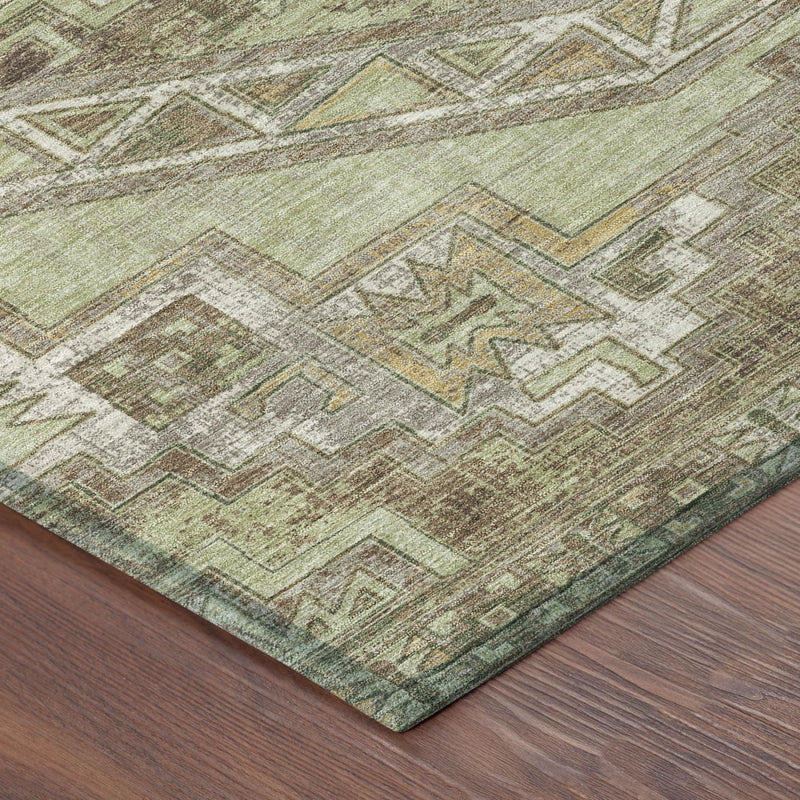 Southwestern washable area rug corner with green, brown, and beige geometric design