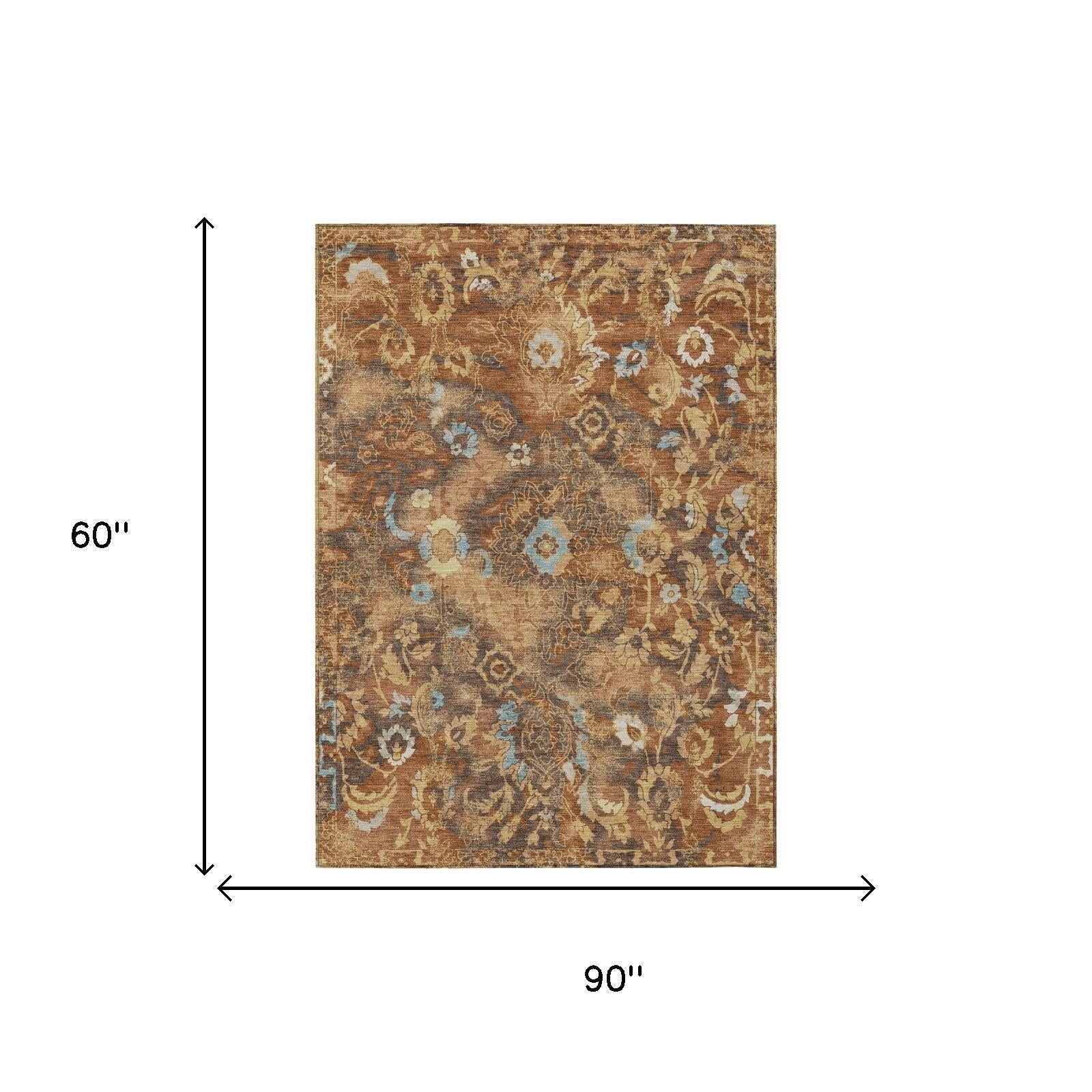 5 ft by 8 ft floral area rug in orange and rust with blue accents