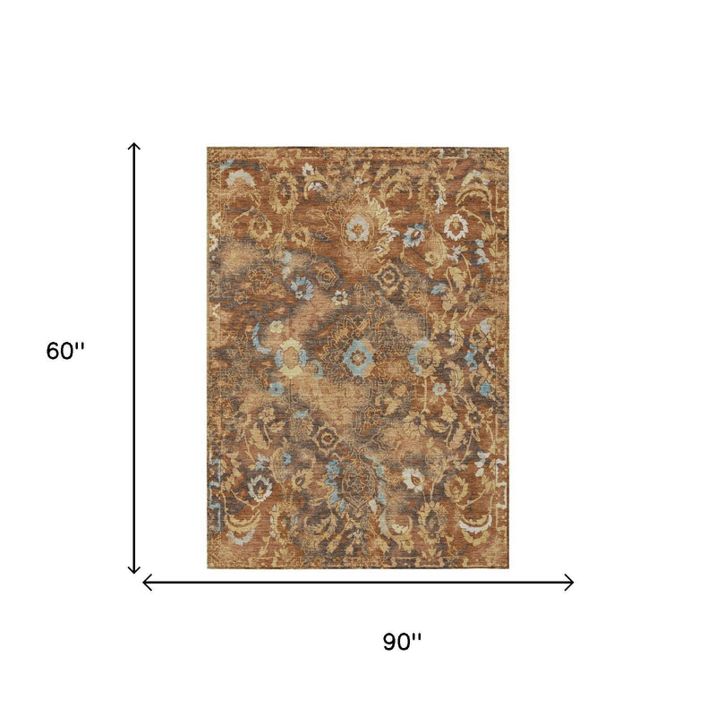 5 ft by 8 ft floral area rug in orange and rust with blue accents