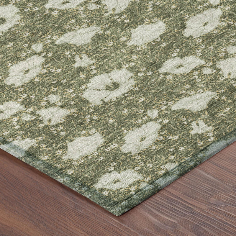 Corner view of area rug with olive-green and light floral pattern