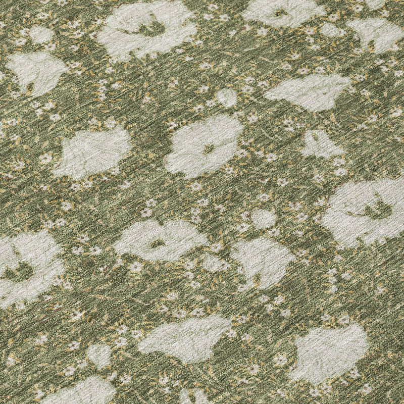 Close-up of area rug with olive-green texture and light floral motifs