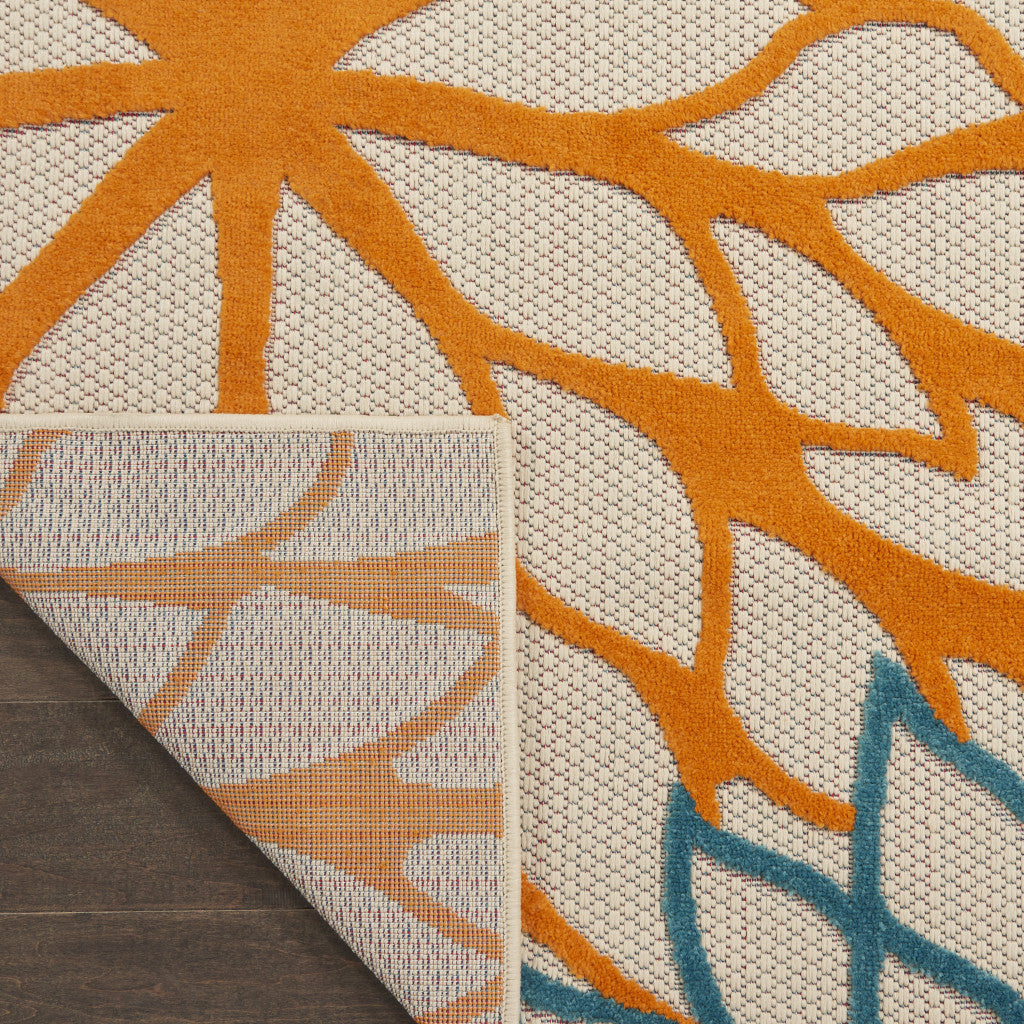 Floral runner rug with orange and cream leaf shapes and a blue accent border corner.