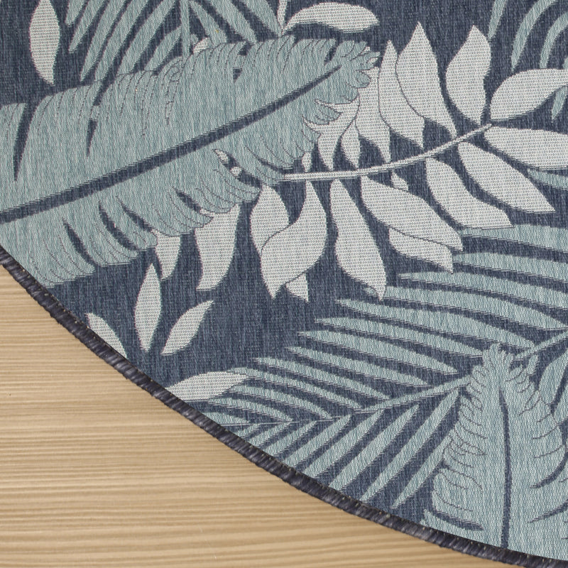 Diagonal view of navy and ivory botanical rug with textured woven backing