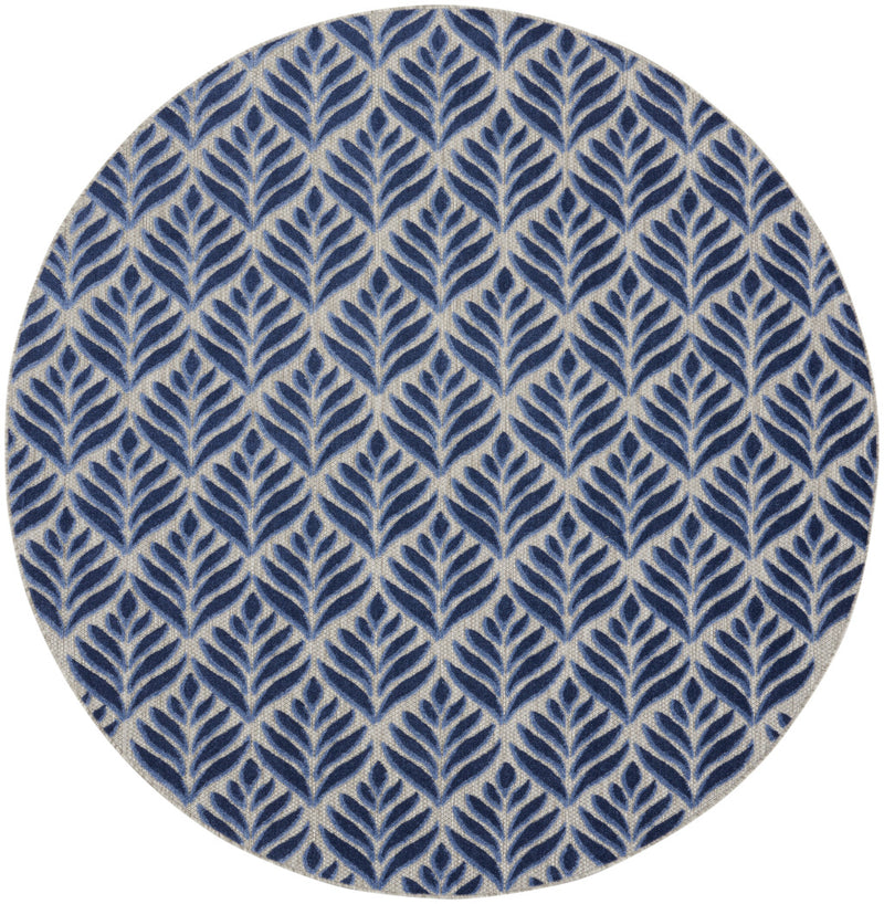 Round blue area rug with dense leaf pattern on light cream background