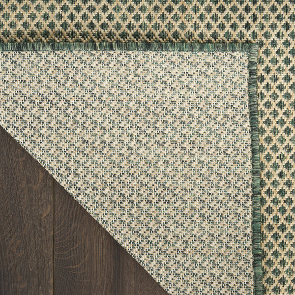 Geometric area rug with green and beige diamond pattern and fringed edge