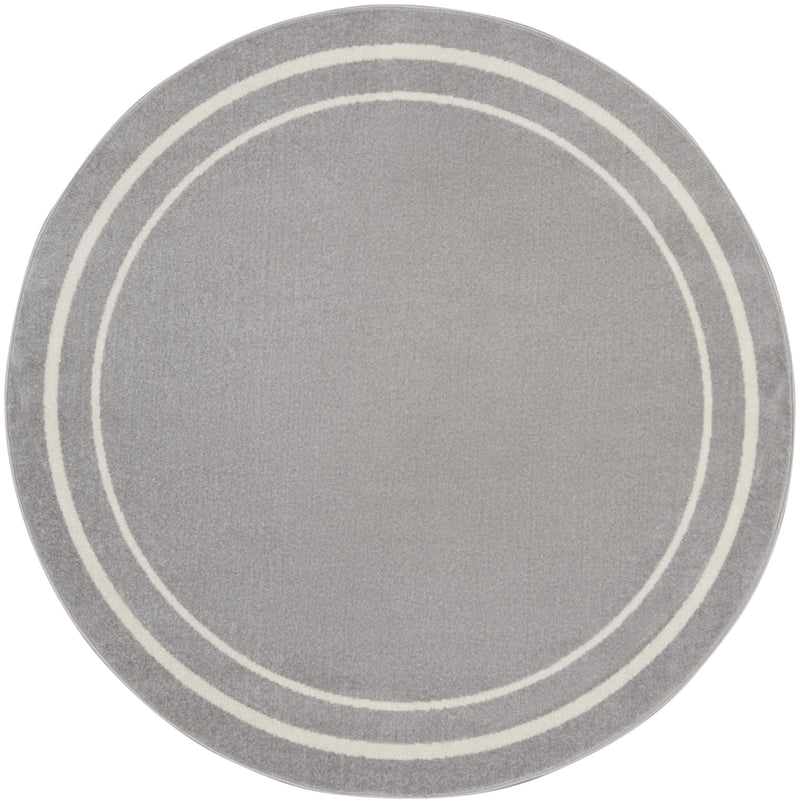 Gray round area rug with three ivory concentric rings and short textured pile