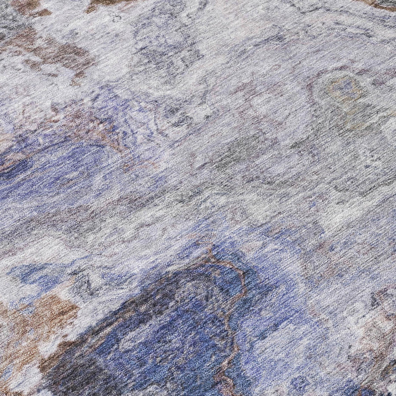 Round abstract area rug close-up, blue and gray mottled distressed texture