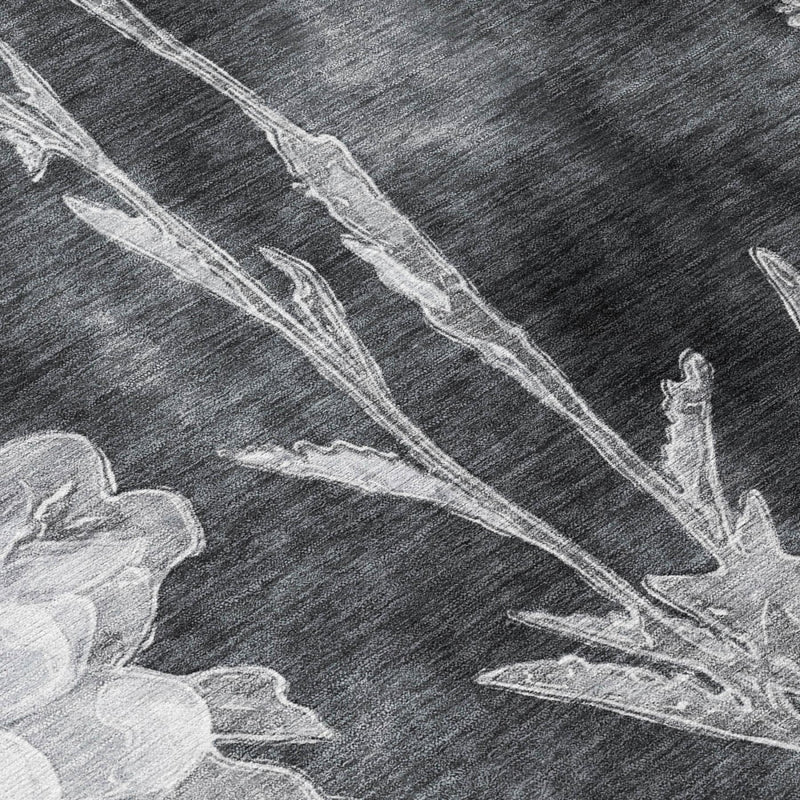 Charcoal area rug close-up with white leaf-and-stem floral linework
