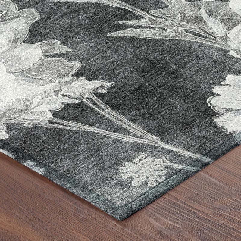 Charcoal area rug corner with white blossoms and stems, textured wash print