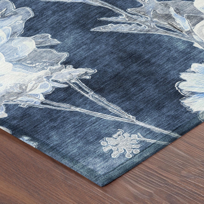 Rug corner with dark navy field and light-blue floral branch motif