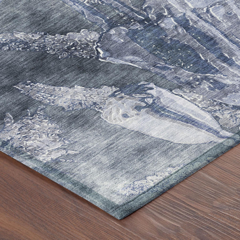 Distressed floral area rug in blue and light lavender with textured abstract motifs