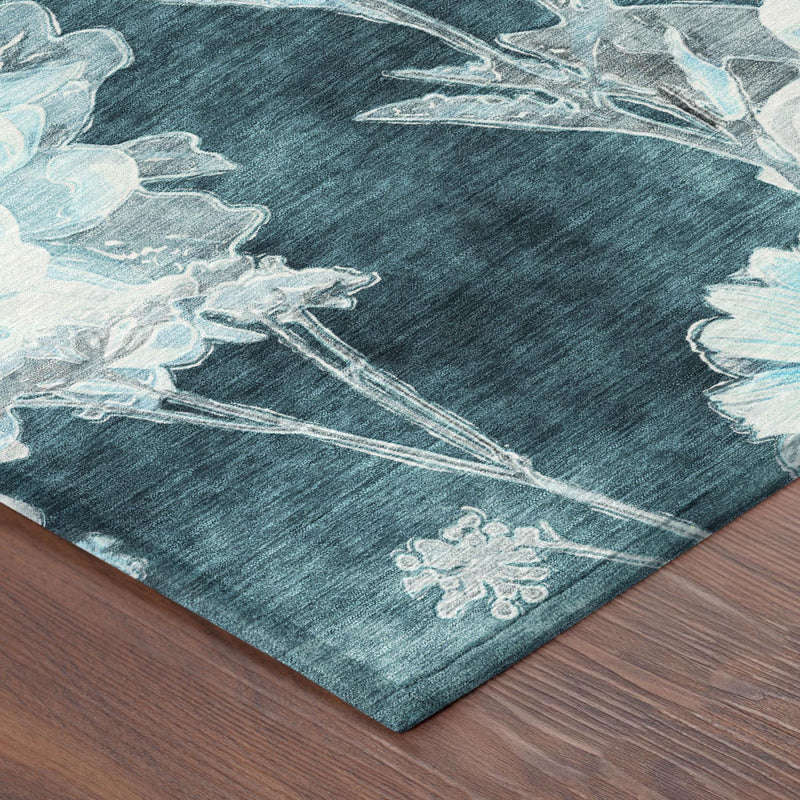 Floral area rug corner detail, dark teal field with pale blue botanical print