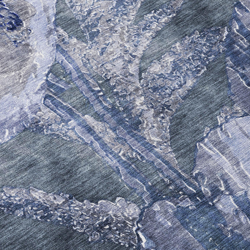 Close-up of round area rug fabric with blue and lavender floral texture