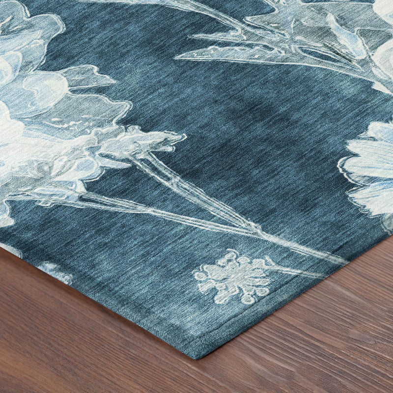 Teal blue area rug corner detail with distressed light blue botanical motif