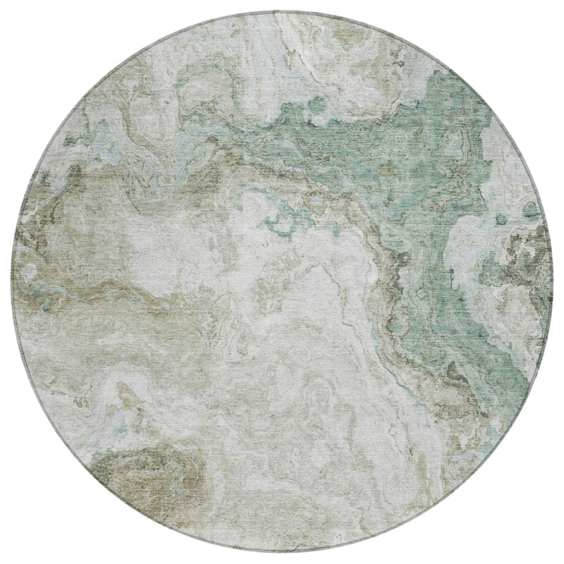 Round area rug with mottled beige base and teal abstract swirls